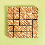 Bueno Brownie squares with white chocolate, milk chocolate drizzle, and crunchy feuilletine pieces by Crumbs & Doilies.